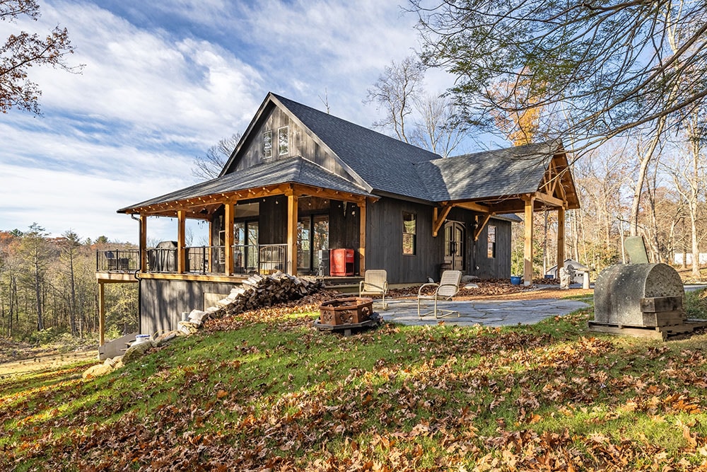 Modern garage with wooden awning and dark siding