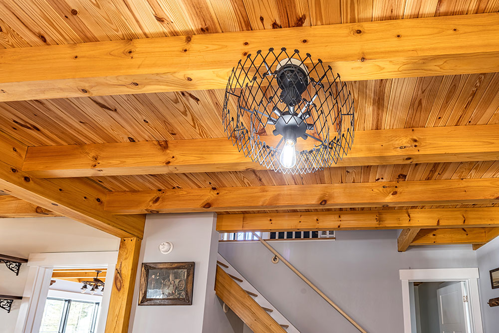 Modern light fixture on wood ceiling