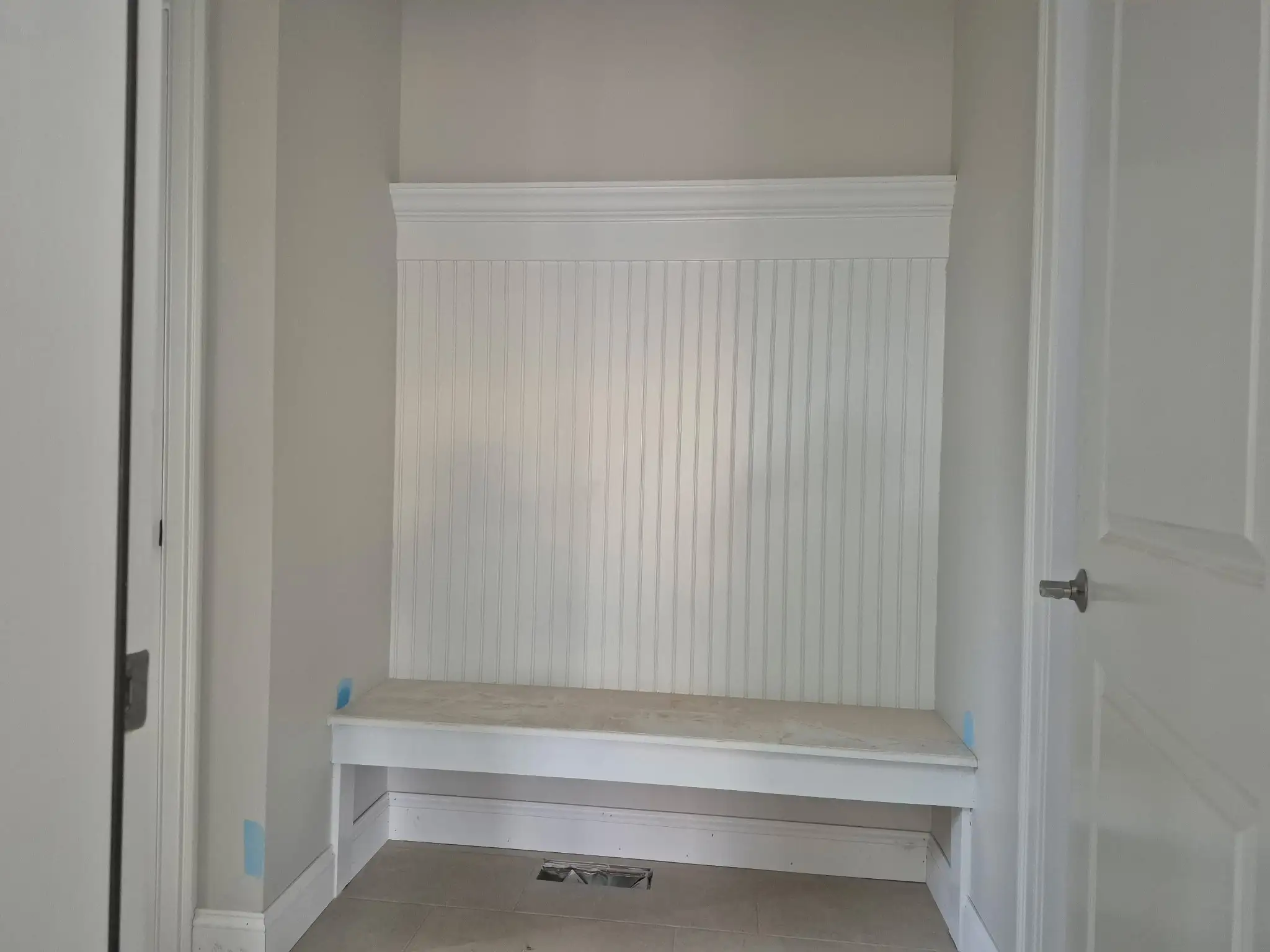 White paneled closet doors with vertical detailing inside the 9 Edith Lane home