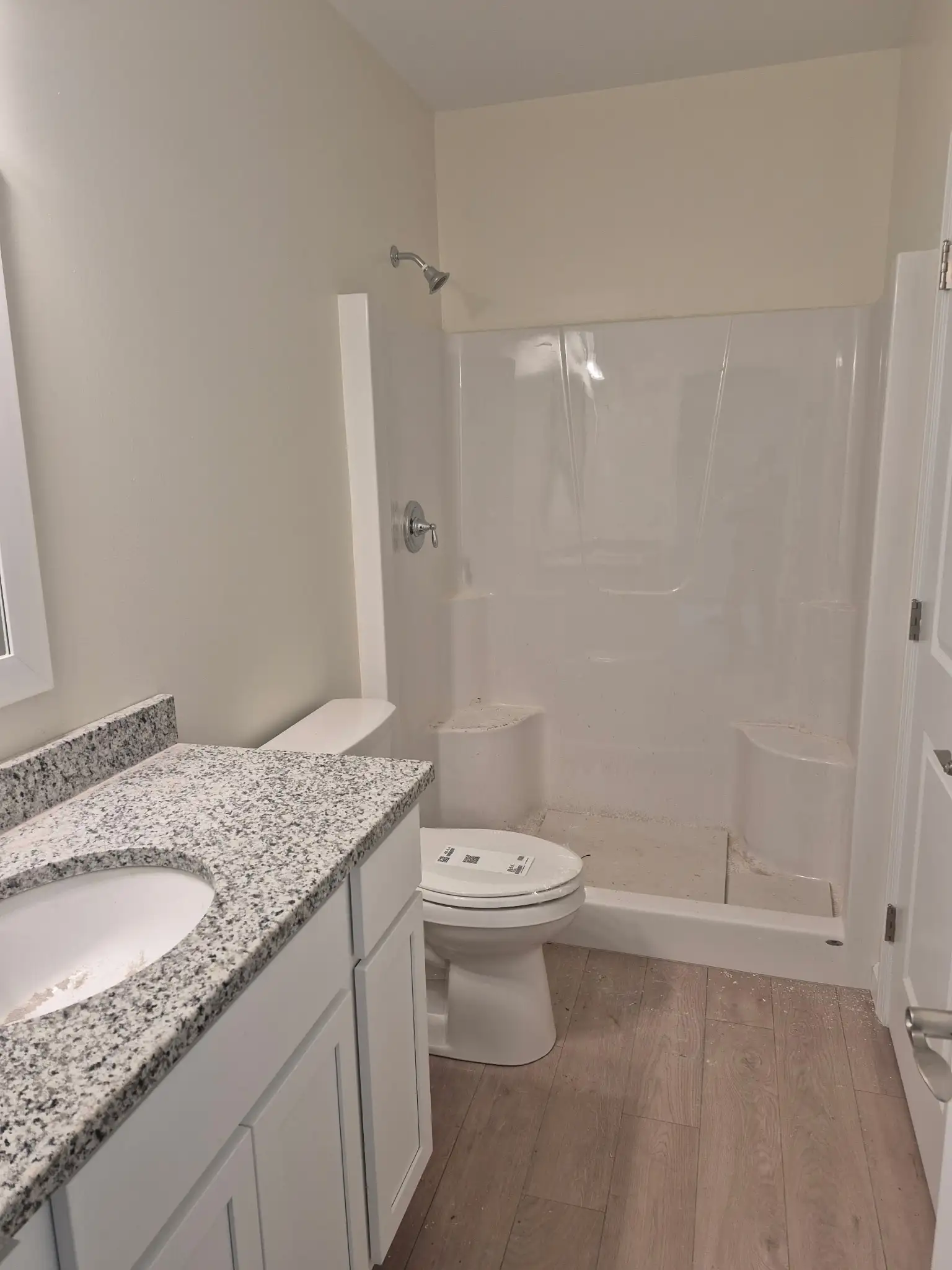 Bathroom featuring white bathtub and shower combination with neutral walls and modern fixtures