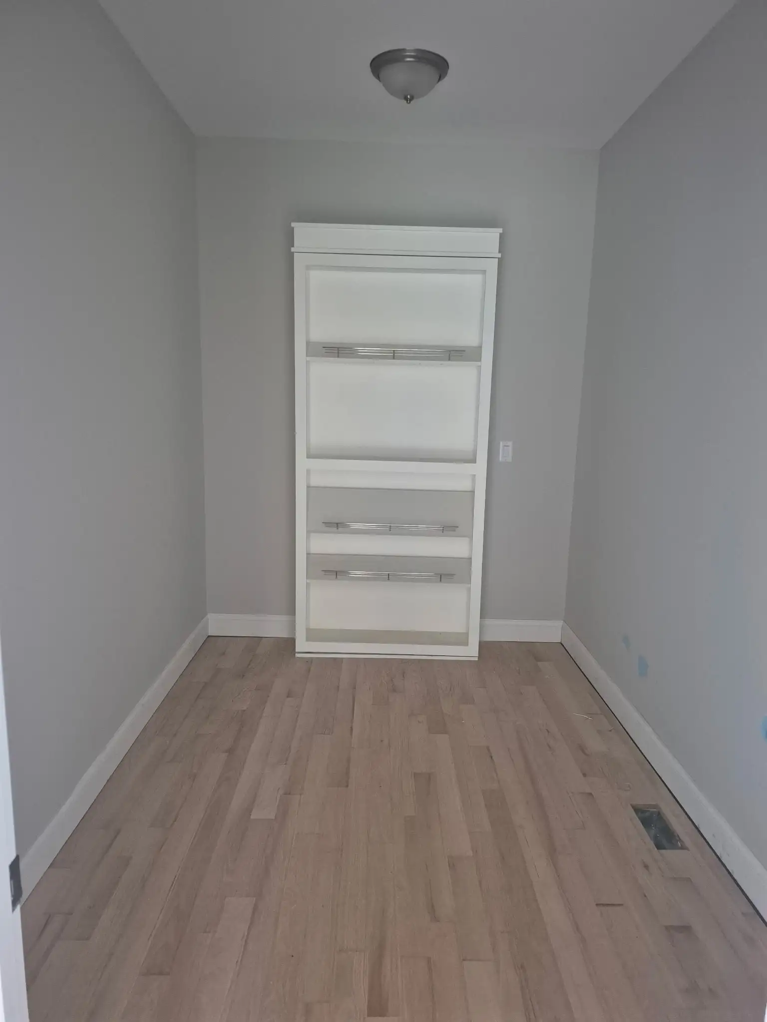 Built-in white storage closet with multiple shelves inside the 9 Edith Lane home