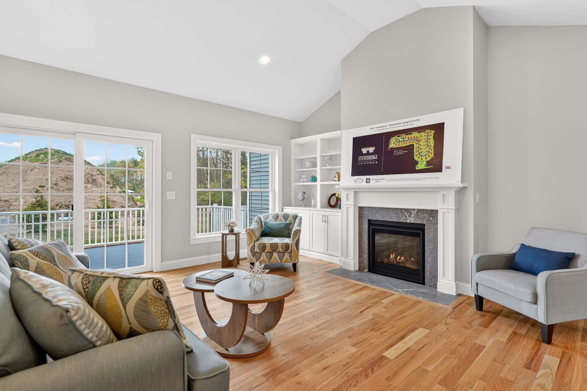 Spacious living room with gas fireplace, large windows and access to an outdoor deck