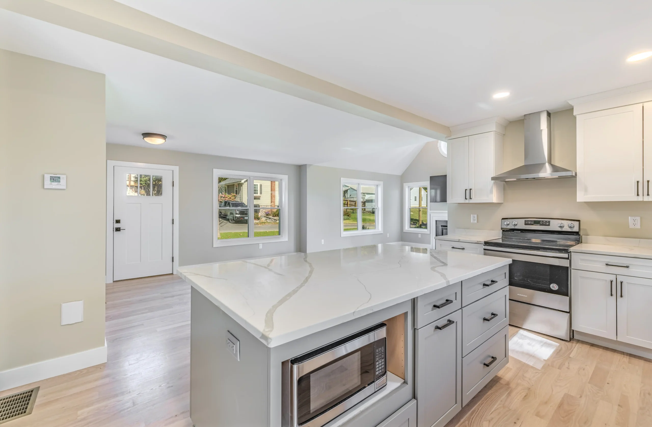 Crystal Lake Home 5 Elm Street Bright Spacious open-concept interior with white kitchen, neutral walls and large windows
