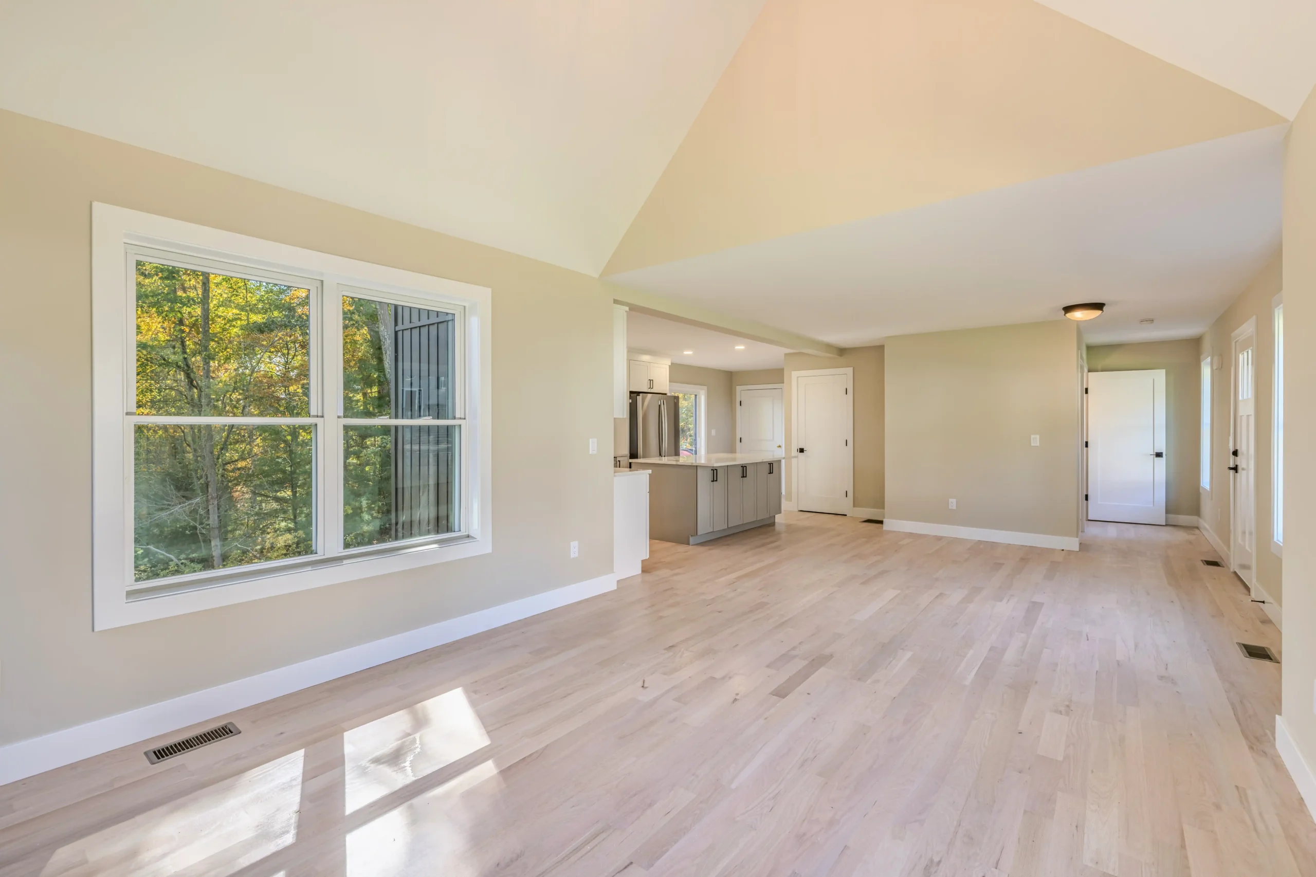 Crystal Lake Home 5 Elm Street Bright living area with large windows and open view toward a modern white kitchen