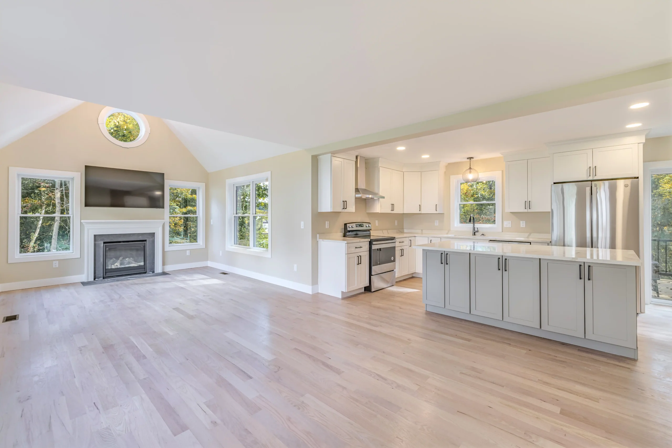 Crystal Lake Home 5 Elm Street - Open-concept living room and kitchen with gray center island and large windows