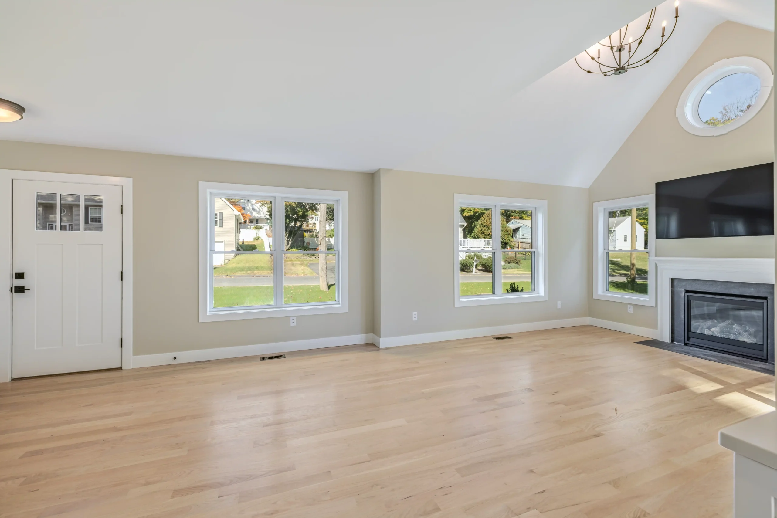 Crystal Lake Home 5 Elm Street Spacious living room with large windows overlooking green lawns and trees