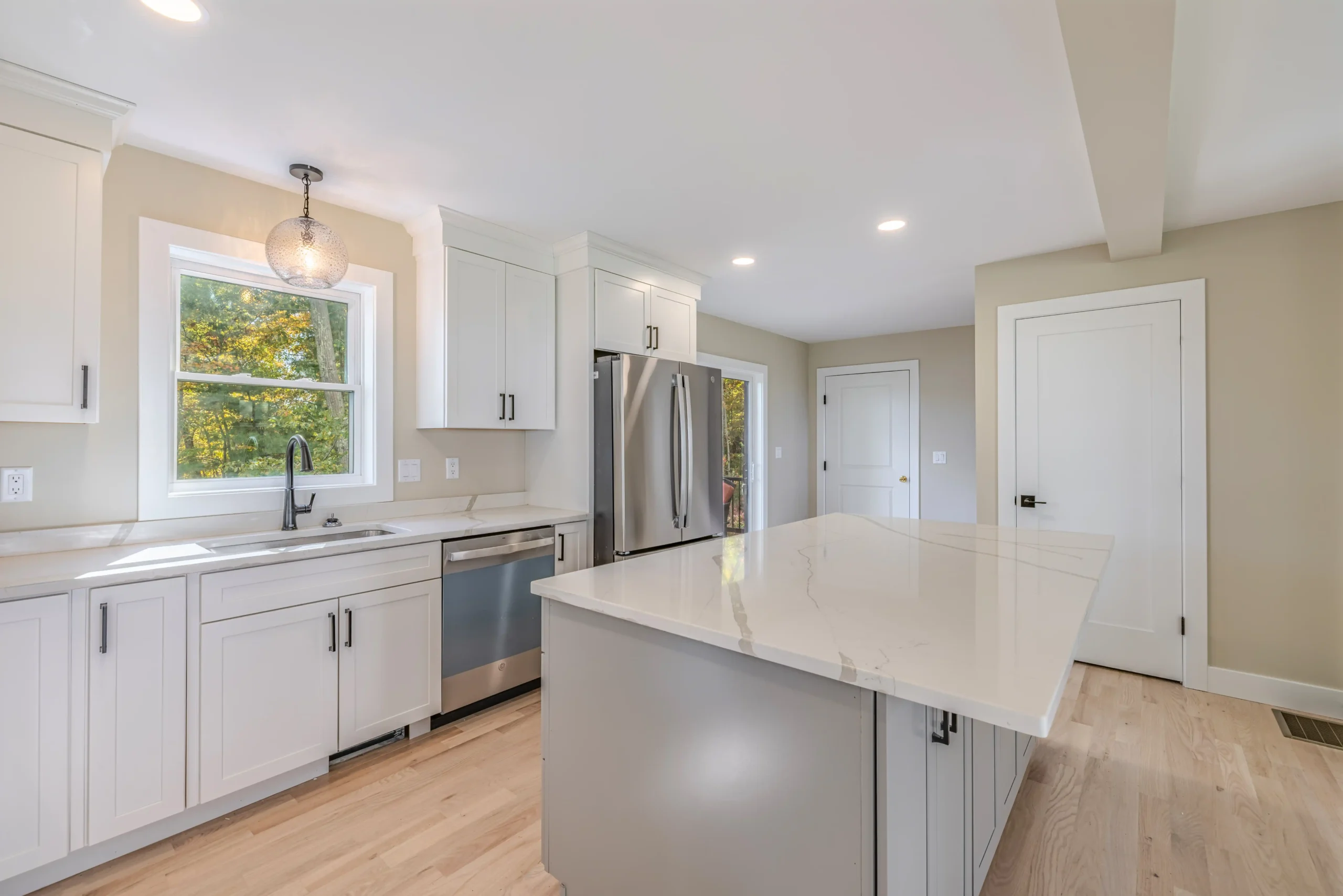 Crystal Lake Home 5 Elm Street Bright kitchen with white cabinets, stainless steel refrigerator and recessed lighting