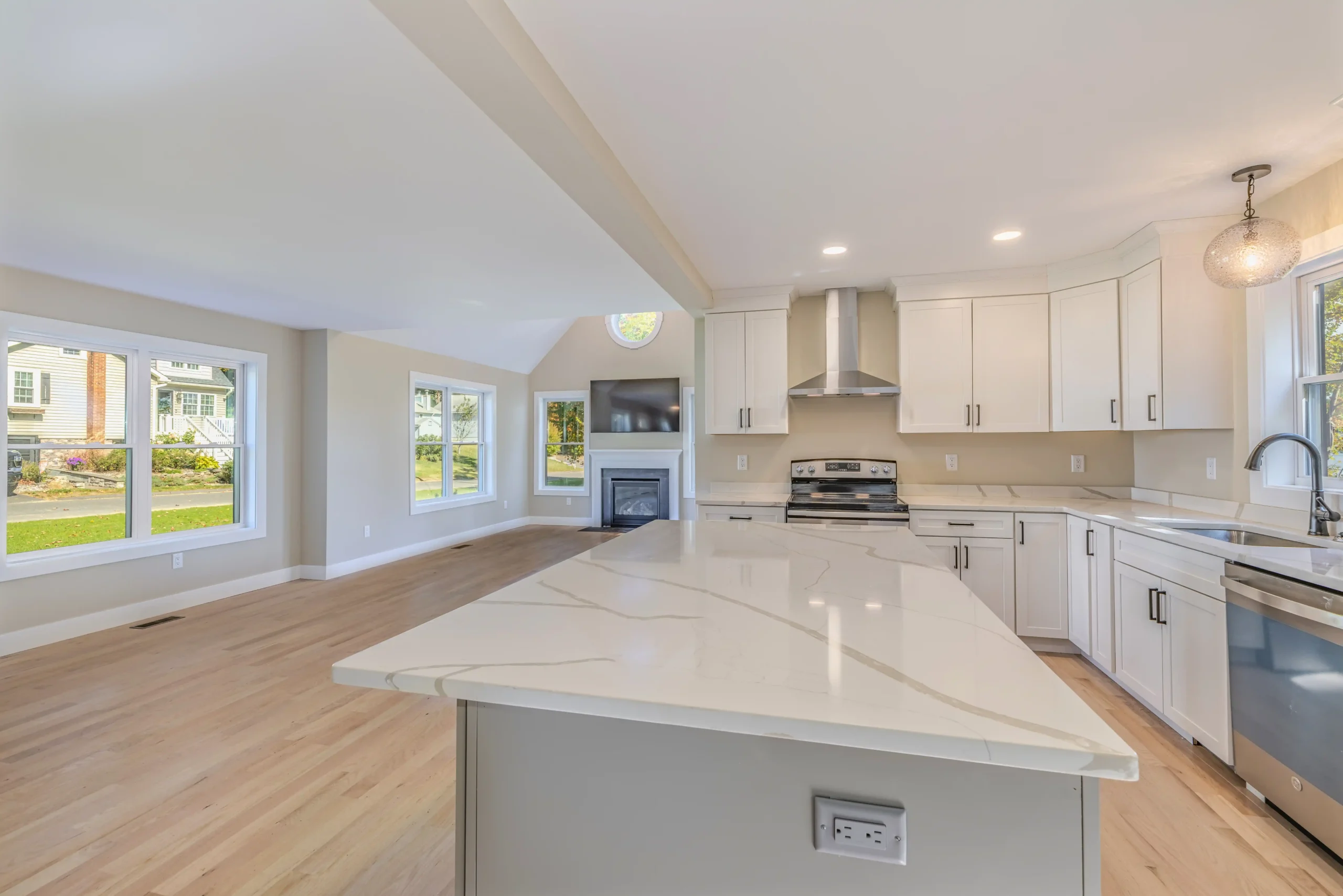 Crystal Lake Home 5 Elm Street Bright Open-concept kitchen and living area with stainless steel range hood and large windows