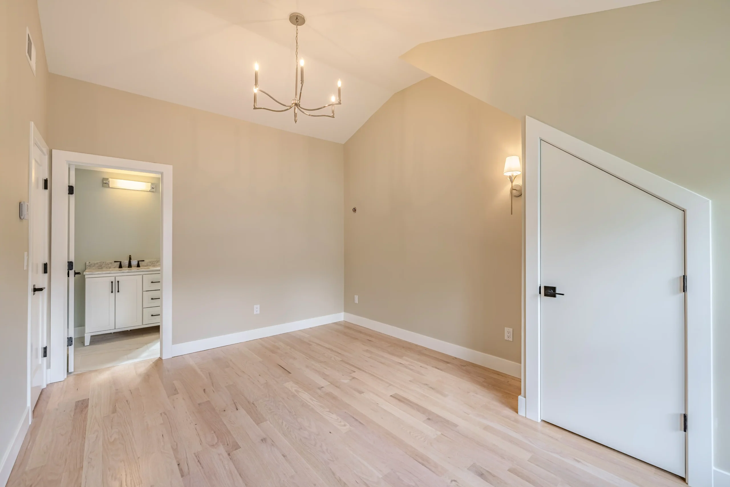 Crystal Lake Home 5 Elm Street Spacious room with sloped ceiling, chandelier, wall sconces and light-colored walls