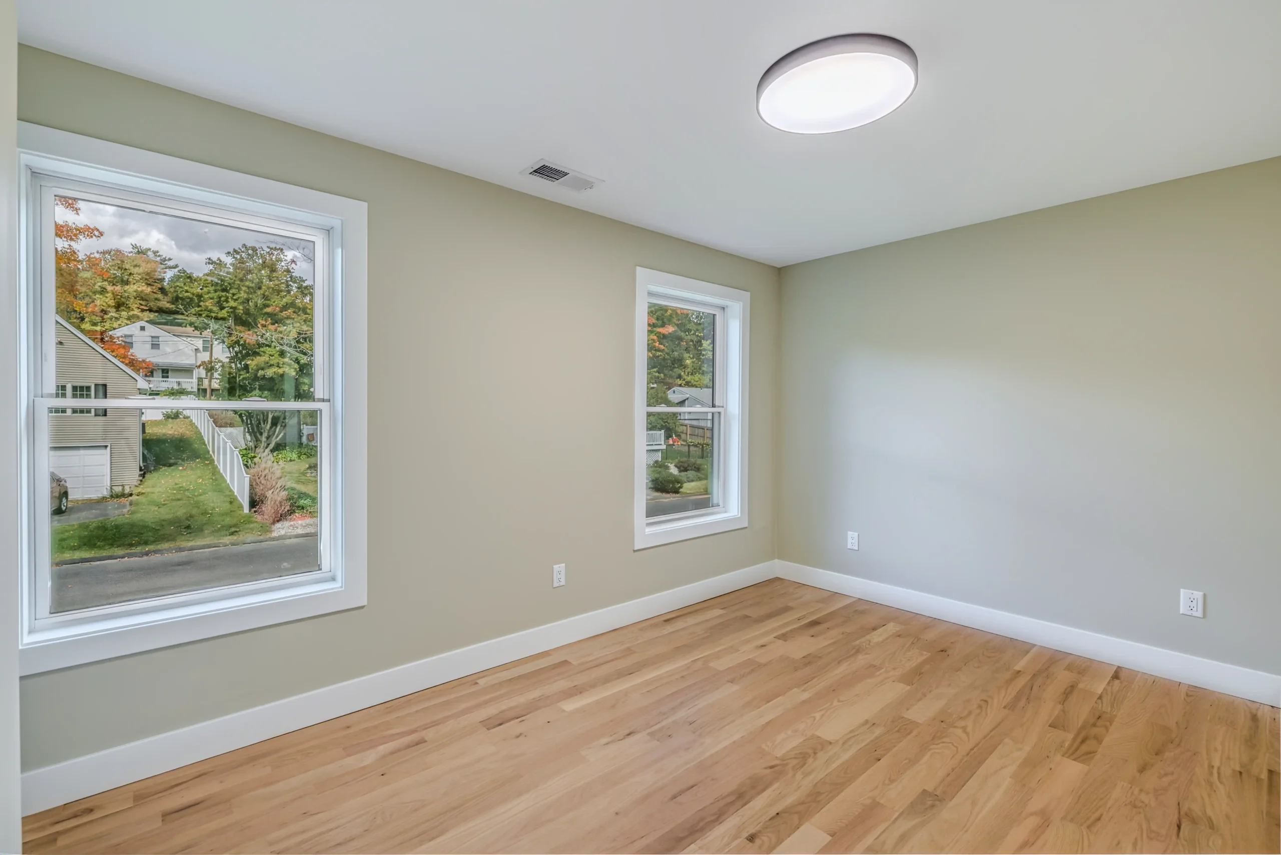 Crystal Lake Home 5 Elm Street Bright bedroom with two windows, neutral walls and ceiling-mounted light