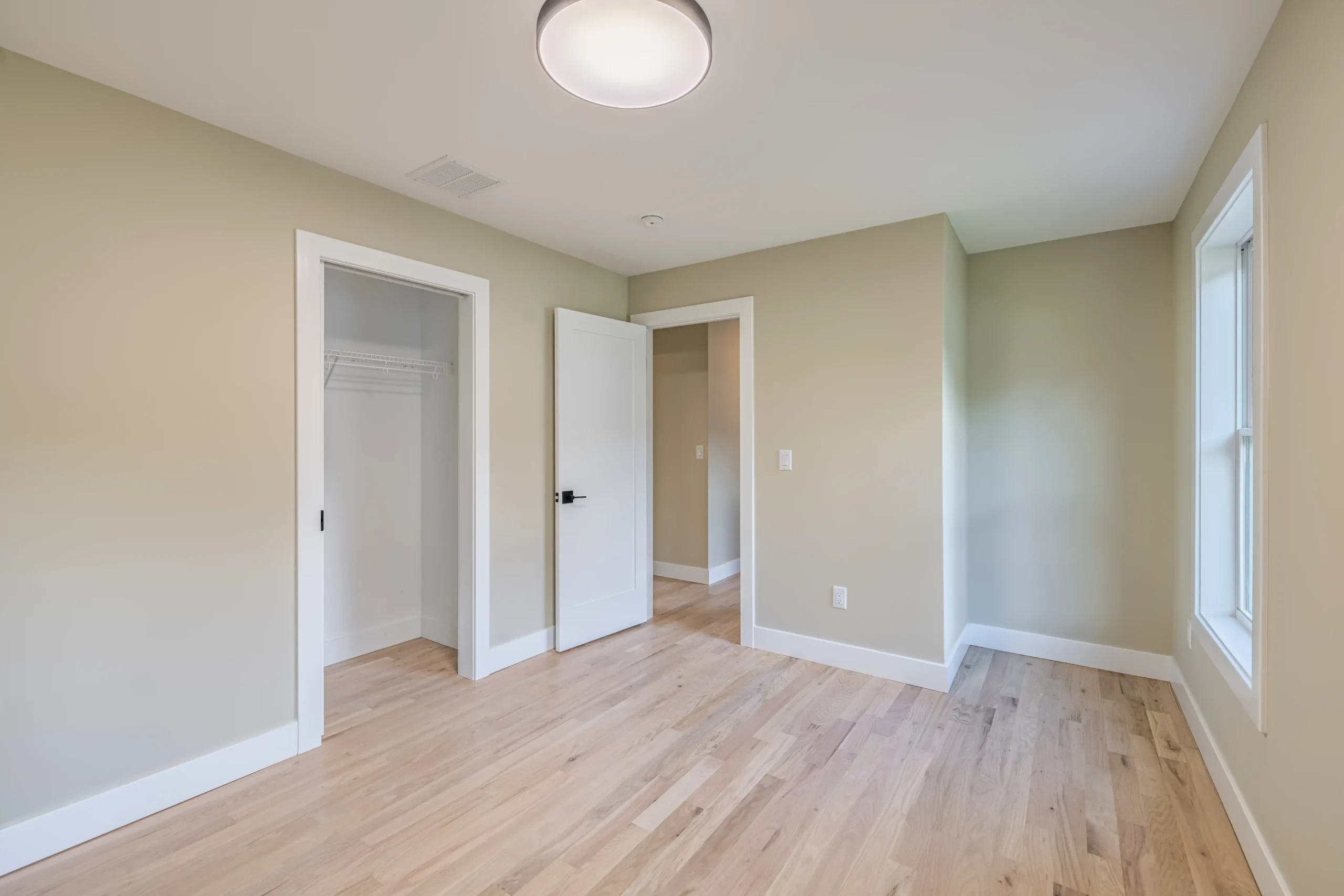 Crystal Lake Home 5 Elm Street Unfurnished bedroom with neutral walls, ceiling light and open doorway