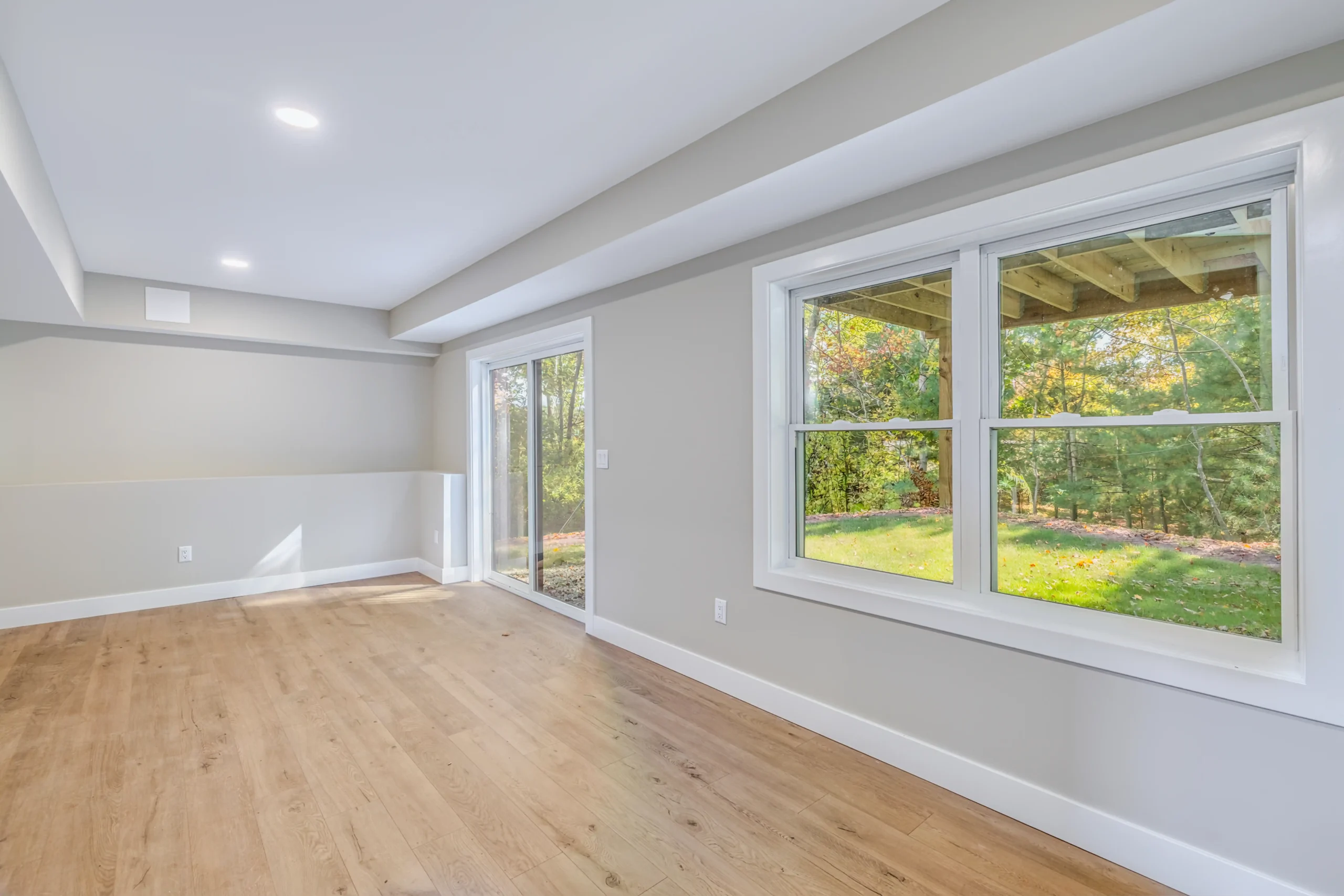 Crystal Lake Home 5 Elm Street Finished lower-level living area with large windows overlooking a green backyard