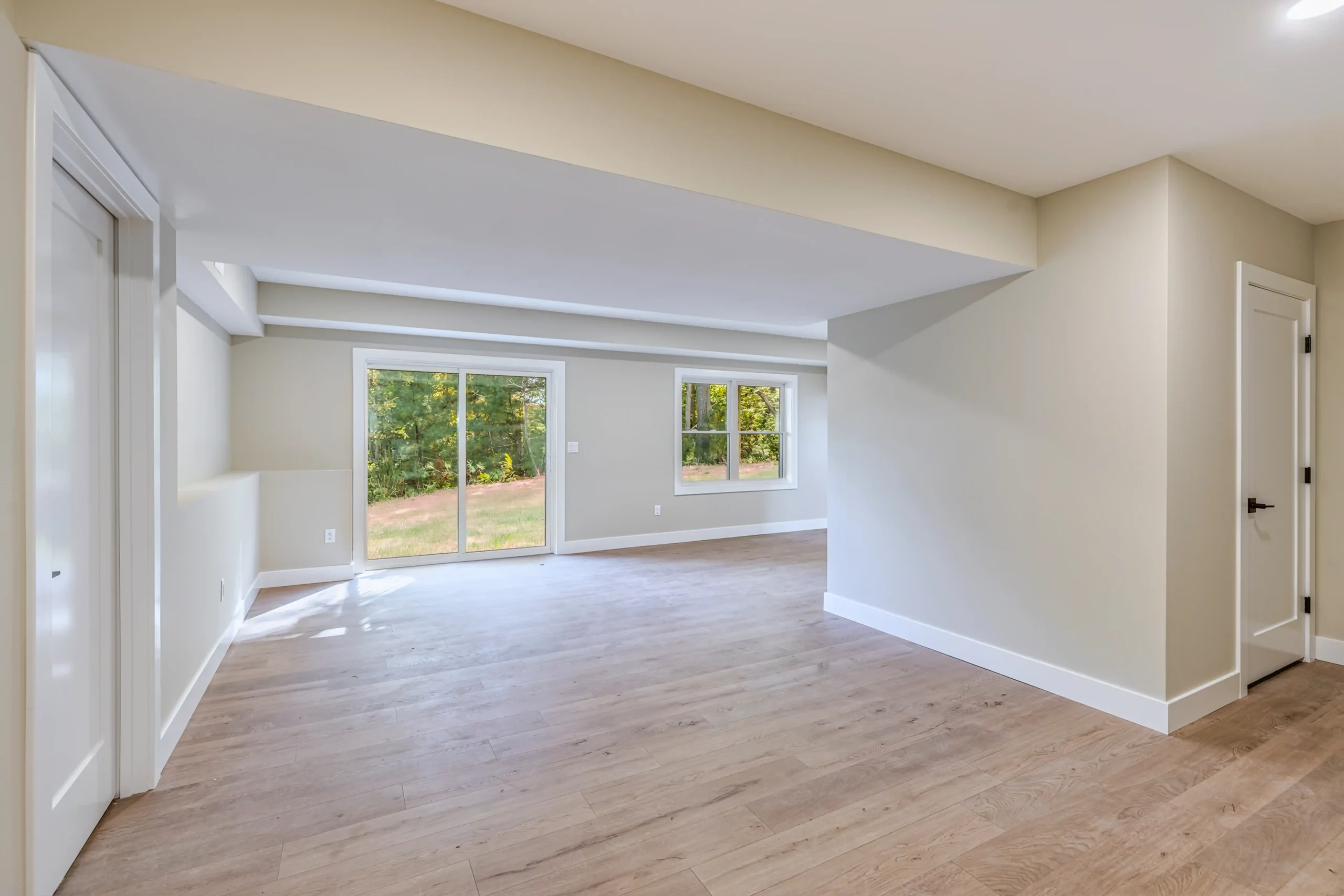 Crystal Lake Home 5 Elm Street Bright finished lower-level room with white walls, large windows and open floor space