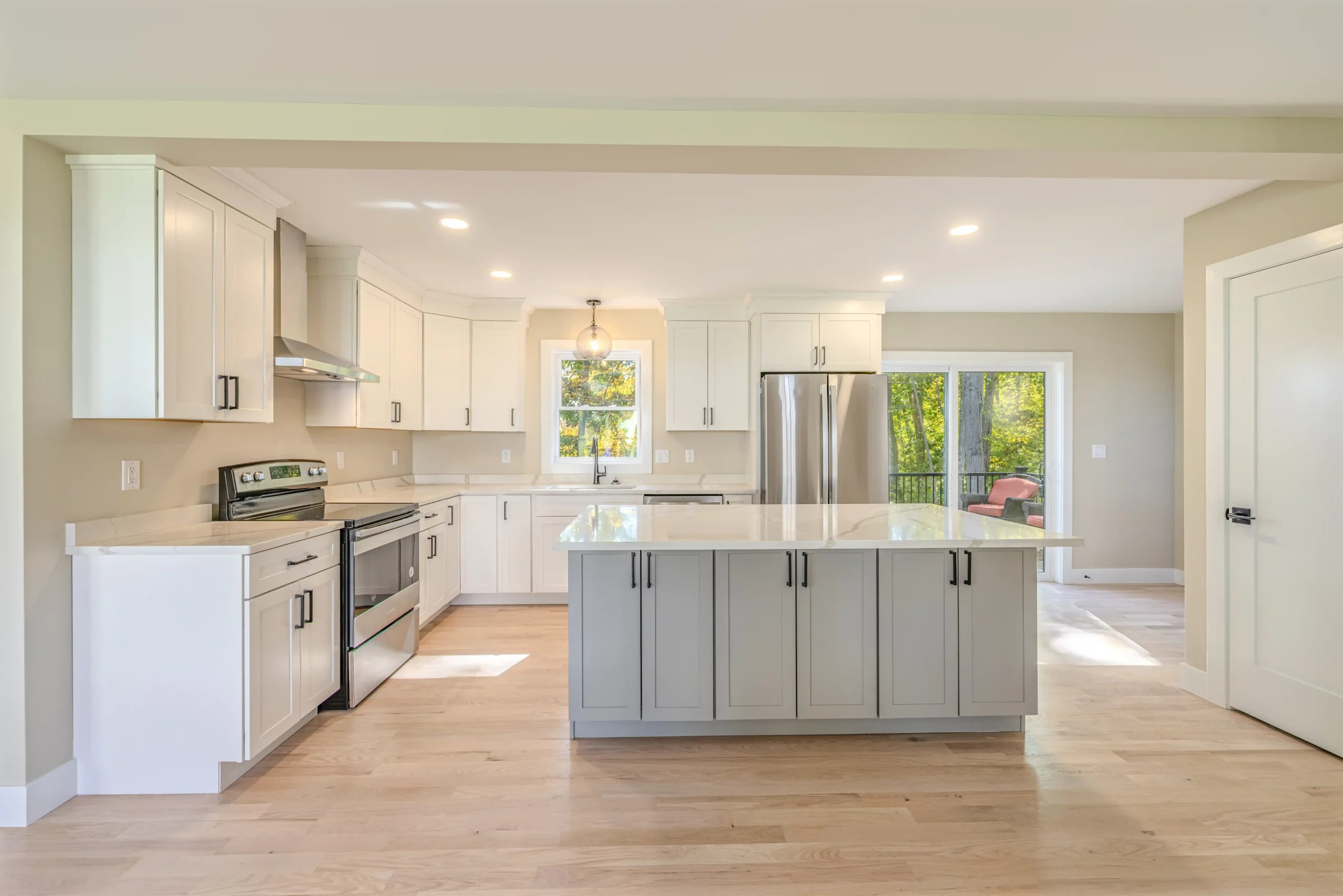 Crystal Lake Home 5 Elm Street Bright Open kitchen with gray center island, white cabinetry and stainless steel appliances