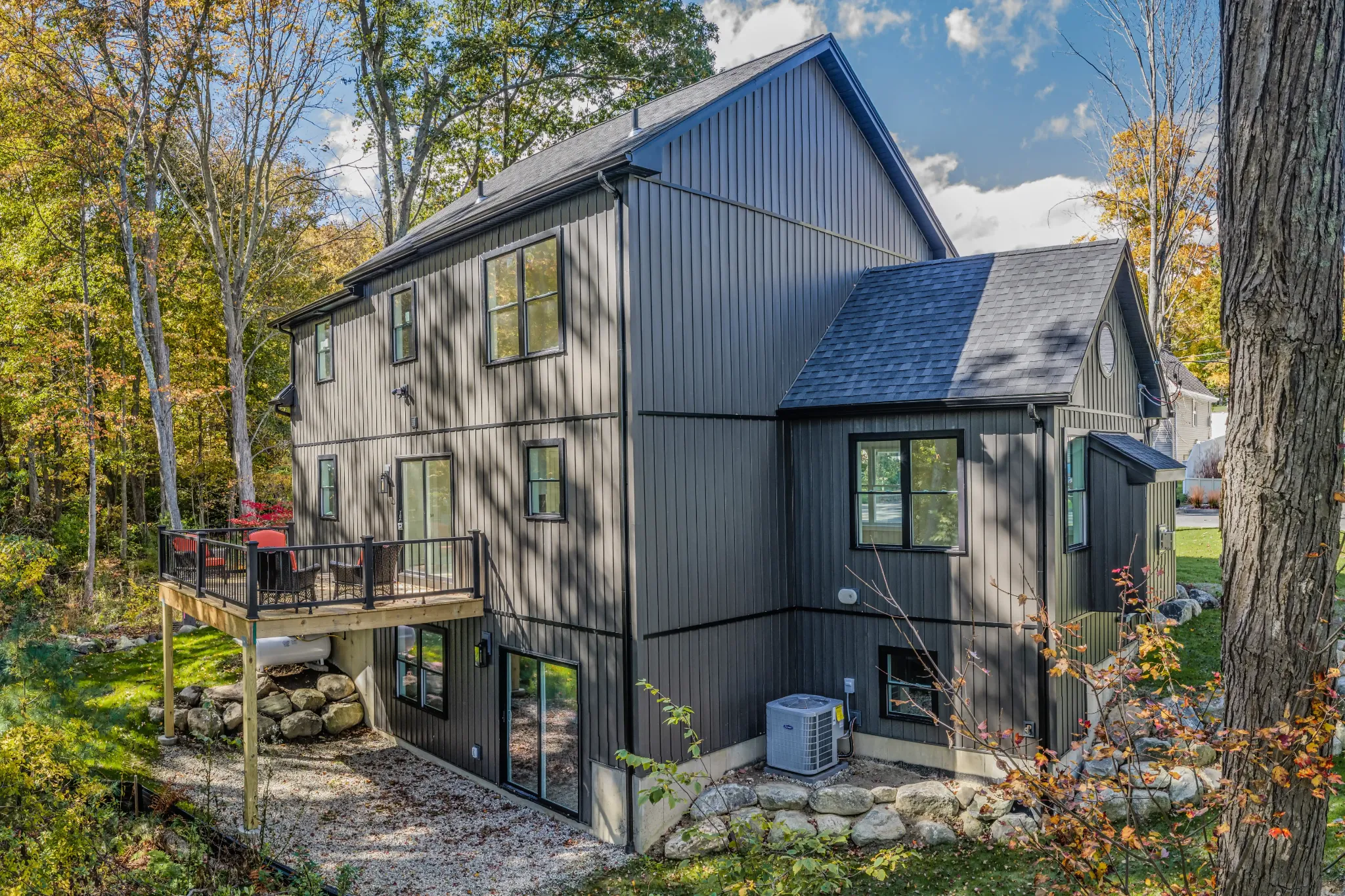 Crystal Lake Home 5 Elm Street Side exterior of dark gray two-story Crystal Lake home surrounded by trees