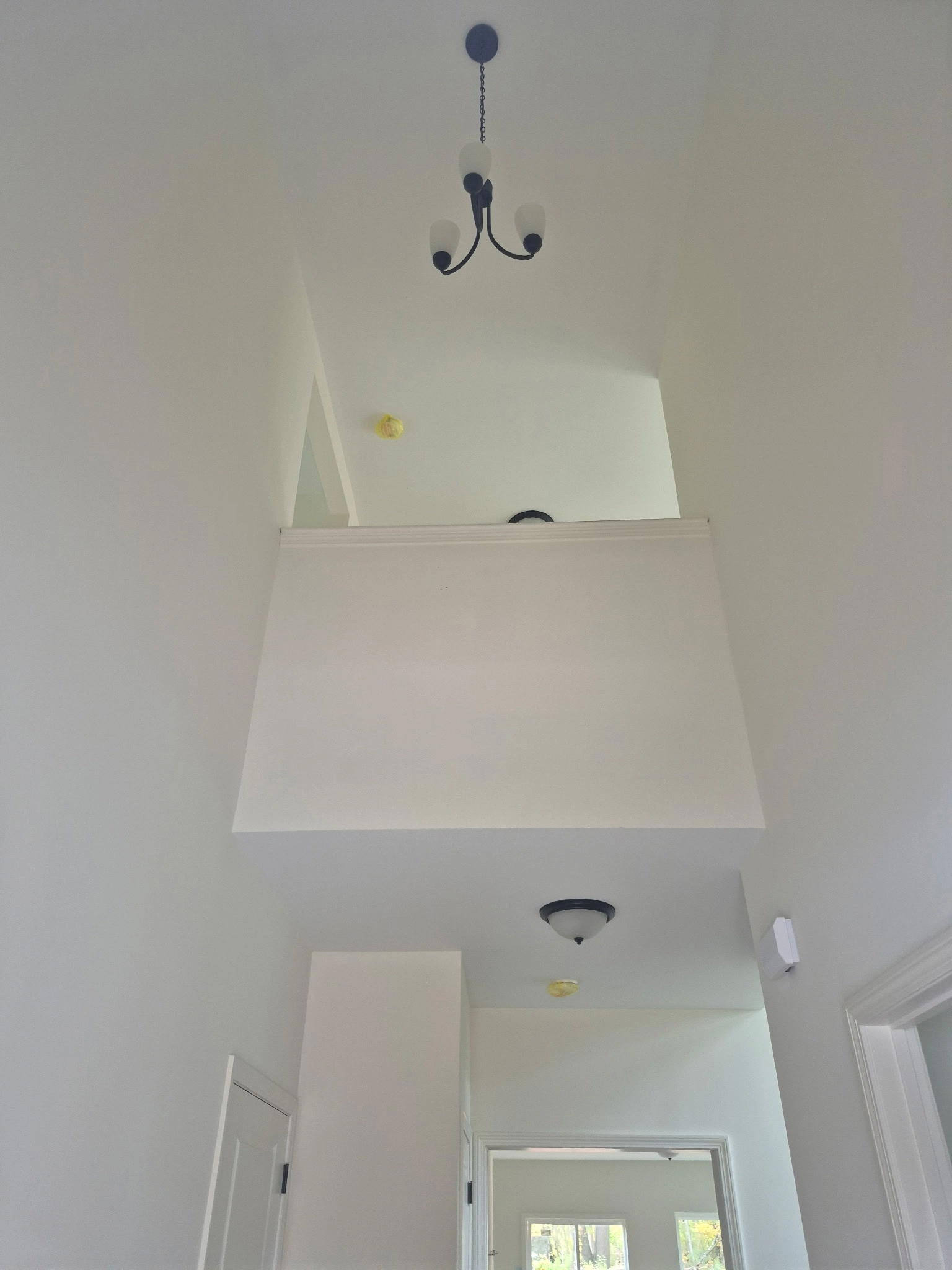 White recessed wall feature with pendant lights