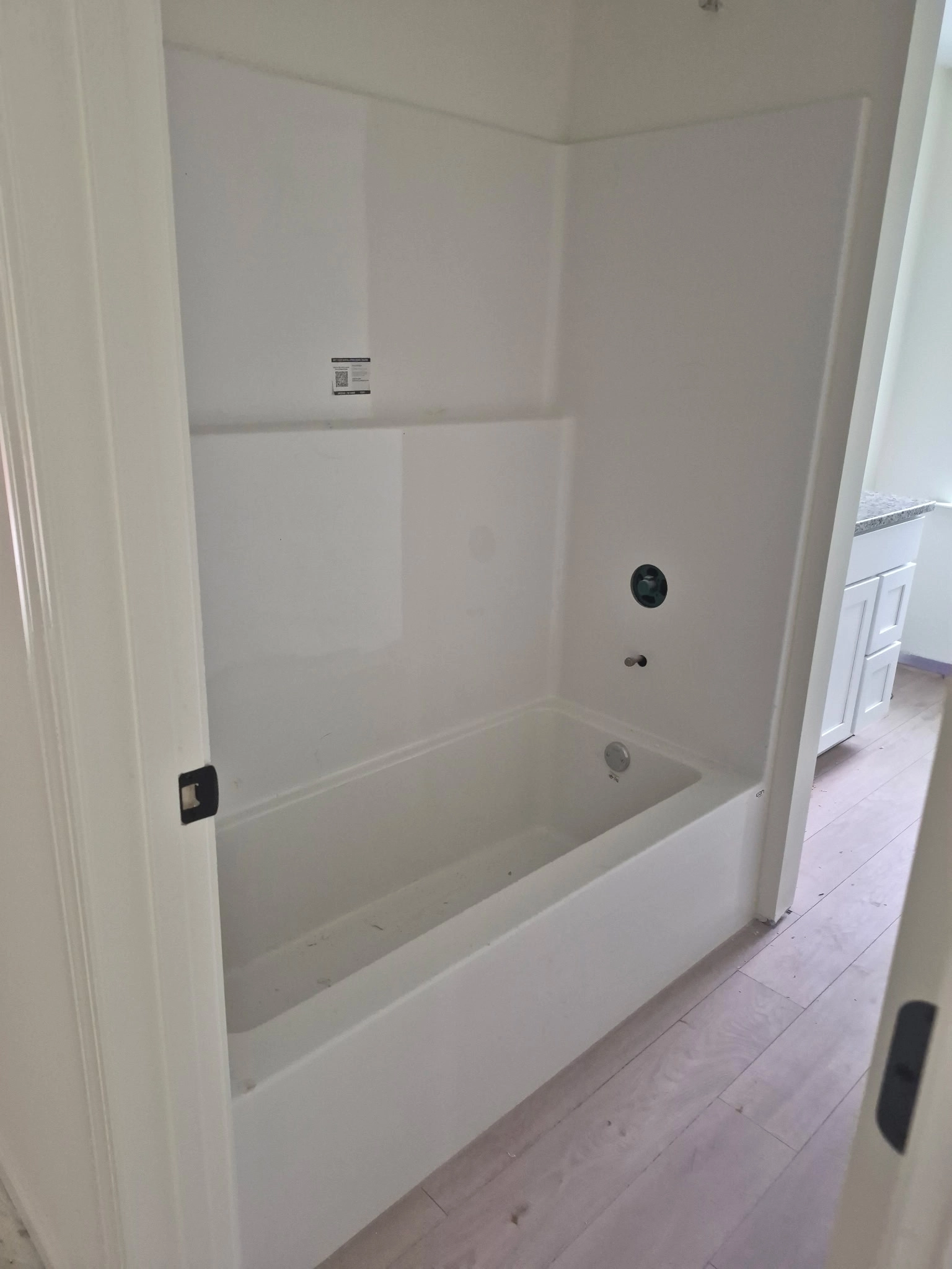 Edith Lane Beverly Farmhouse White bathtub and shower combination with built-in surround